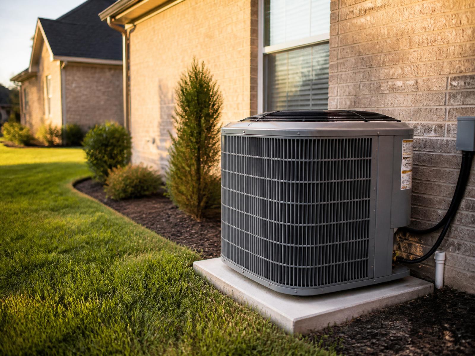Residential air conditioning condenser installed beside a Tennessee home